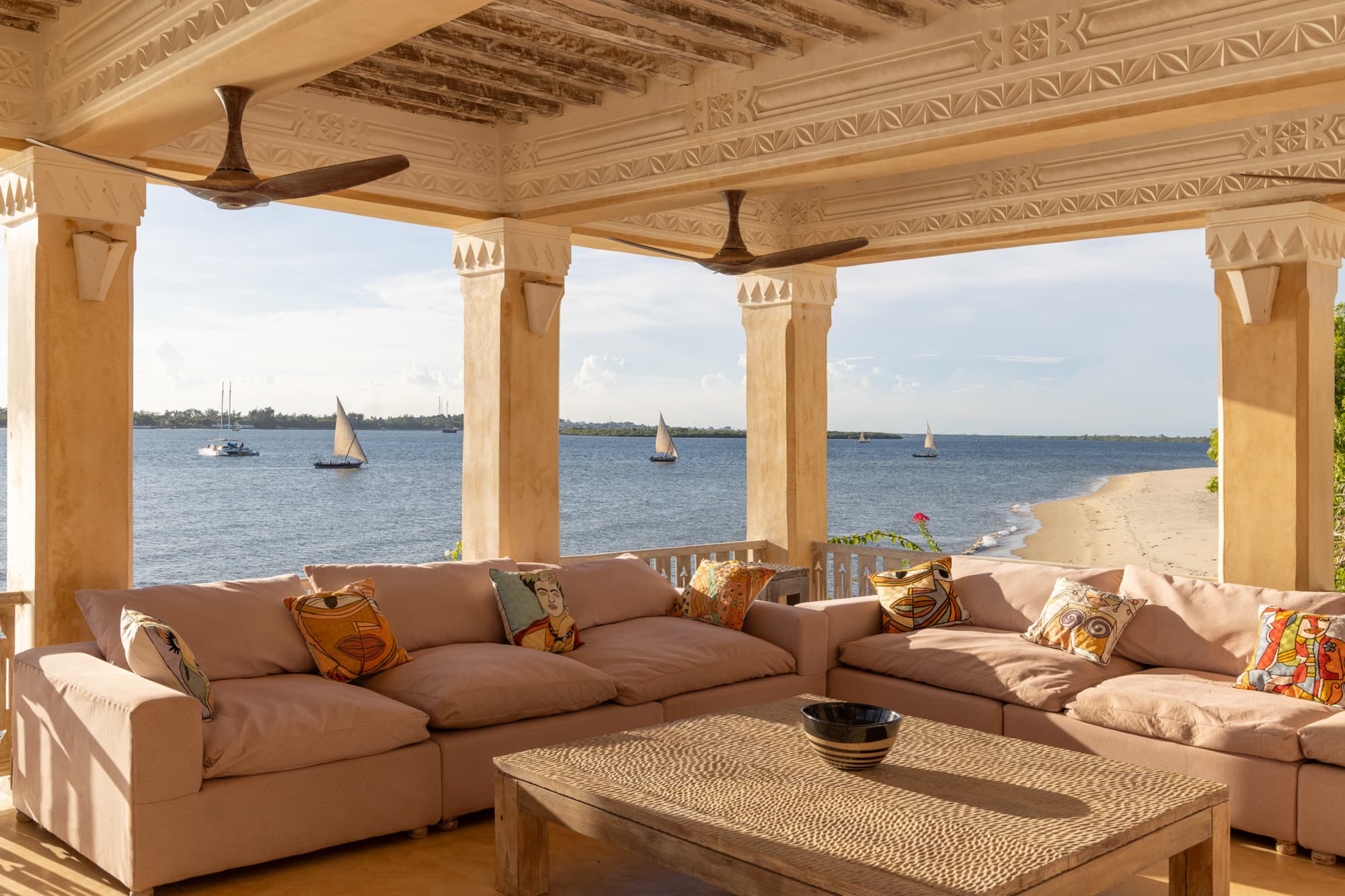 Ocean-view terrace lounge with dhows on the horizon
