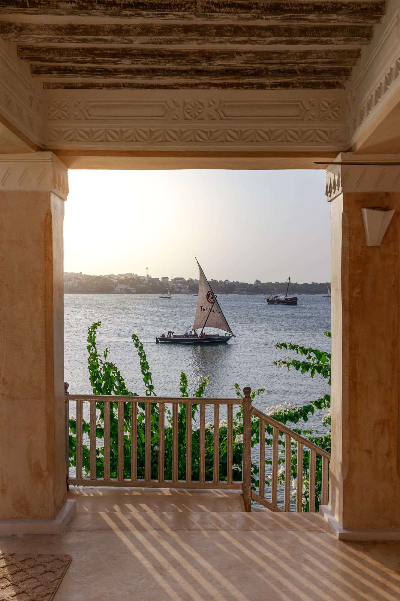 Dhow seen through a carved veranda archway